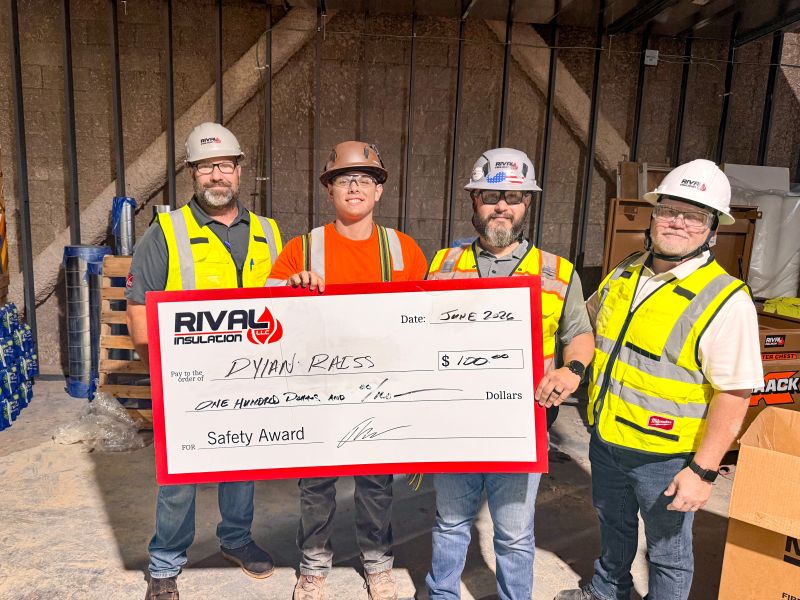 Rival Insulation team members holding a $100 Safety Award check